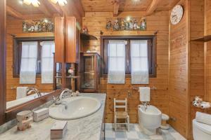 a bathroom with a sink and a toilet and a tub at La Lanterna Swimming Pool Retreat - Happy Rentals in Gignese +33 photos
