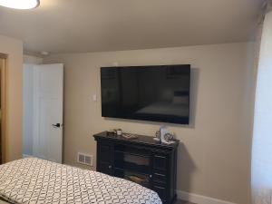 a bedroom with a bed and a flat screen tv on the wall at 2 bdrm, Walking distance to all in Florence