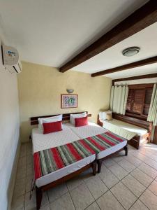 Cama ou camas em um quarto em Pousada Tambayba