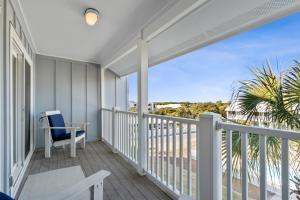 a balcony with a chair and a view of the ocean at Sea Bluff of 30A Unit 10 in Santa Rosa Beach