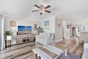a living room with a couch and a tv at Sea Bluff of 30A Unit 10 in Santa Rosa Beach +54 photos