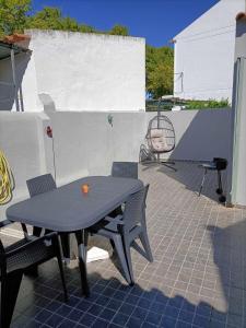 a table and chairs sitting on a patio at Apartamentos São Sebastião in Évora