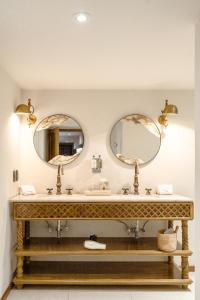 a bathroom with two sinks and two mirrors at Casa 63 Hotel Boutique & Spa in San Miguel de Allende +45 photos