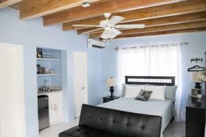 a bedroom with a bed and a ceiling fan at Tangerine Sunsets Alta Vista Studio One in Nassau +27 photos