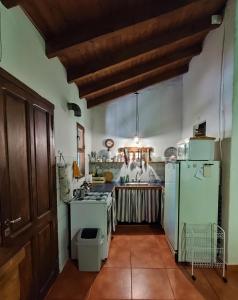 a kitchen with a stove and a refrigerator at La Chacrita in Chacras de Coria