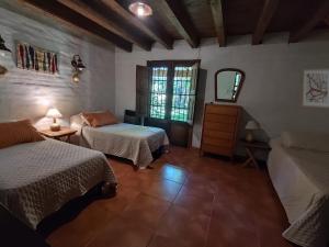 a bedroom with two beds and a window at La Chacrita in Chacras de Coria +20 photos