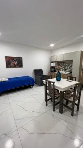 a living room with a table and a couch at Residencial Europa in Bombinhas +8 photos