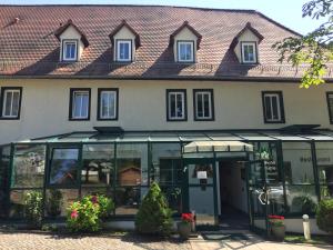a building with a glass door in front of it at Waldhotel Linzmühle in Kahla