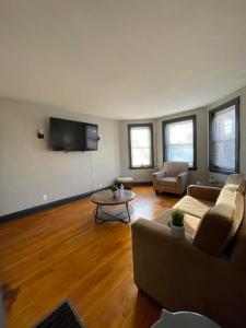 a living room with a couch and a table at Modern 1BR Outdoor Space & Cozy Vibes in Chicago