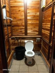 a wooden bathroom with a toilet in a stall at Vangngo View Resort, Muang Fuang in Muang Fuang