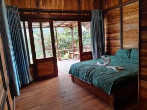 a bedroom with a bed with a stuffed animal on it at Vangngo View Resort, Muang Fuang in Muang Fuang