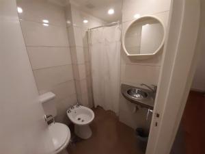 a small bathroom with a toilet and a sink at Hotel Messina in Mar del Plata
