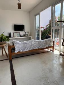 a couch in a living room with a large window at Casa Free Wind Jeri in Jericoacoara