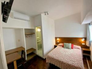 a small bedroom with a bed and a closet at Hotel Messina in Mar del Plata +17 photos