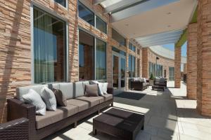 a patio with a couch on a building at Courtyard by Marriott Ardmore in Ardmore