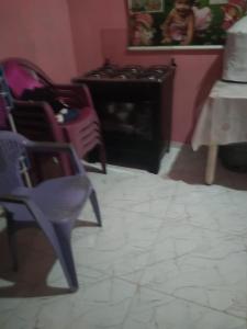 a room with chairs and a table with a cake at Casa da vovó Alessandra in Belém