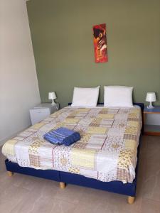 a bedroom with a bed with a quilt on it at Florecita 2 in Ngaring