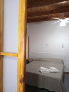 a bedroom with a bed with two towels on it at Casa Silvia in Bahía Blanca