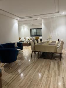 タンジェにあるAppartement de LUXEのテーブルと椅子とソファのあるリビングルーム