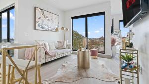 a living room with a couch and a table at NEW! ChateauOasis PenthouseViews KingBed FreePark in Atlanta