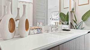 a white bathroom with a sink and a mirror at NEW! ChateauOasis PenthouseViews KingBed FreePark in Atlanta