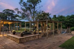 a patio with a pavilion with tables and chairs at Protea Hotel by Marriott Bloemfontein Willow Lake in Bloemfontein