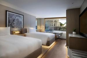 Postel nebo postele na pokoji v ubytování JW Marriott Auckland