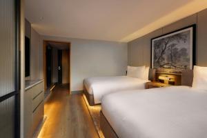 Postel nebo postele na pokoji v ubytování JW Marriott Auckland