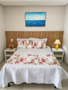 a bedroom with a large bed with flowers on it at Recanto sol nascente in Rio Formoso +27 photos