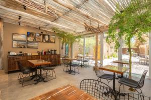 a restaurant with tables and chairs and plants at Casa Solcor Boutique Bed & Breakfast in San Pedro de Atacama