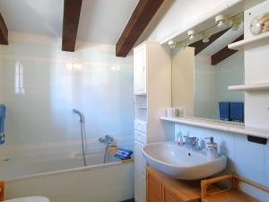 a bathroom with a sink and a bath tub at House in Luino with Green Garden and City Views in Luino +25 photos