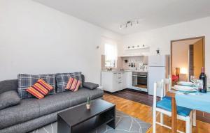 a living room with a couch and a table and a kitchen at Apartments for families with children Jasenak, Karlovac - 17501 in Jasenak
