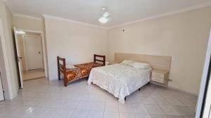 a bedroom with a bed and a chair in it at Casa das flores in Sao Paulo +25 photos