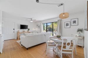 a living room with a couch and a table at Sea Esta 30A Beautiful Condo Close To Beach in Seagrove Beach