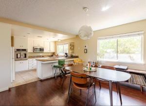 a kitchen and dining room with a table and chairs at Mid-Century Hideaway - privat Pool & King Bed in Yucca Valley
