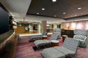 a lobby with chairs and a waiting room with a bar at Courtyard by Marriott Asheville in Asheville