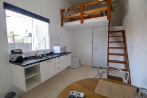 a kitchen with a sink and a ladder in a room at Pousada jardim do Sol in Sorocaba