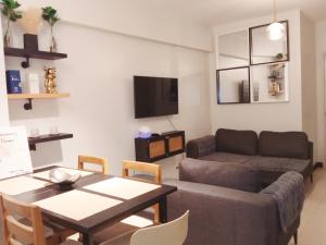 a living room with a couch and a table at Cozy 2BR Condominium Unit- Verdon Parc in Davao City