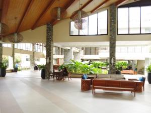 a lobby with couches and tables in a building at Cozy 2BR Condominium Unit- Verdon Parc in Davao City