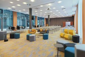 a conference room with tables and chairs and tablesktop at Courtyard by Marriott Berlin City Center in Berlin