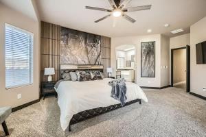 a bedroom with a large bed and a ceiling fan at Whitton House - Hot Tub - Fire Pit - Pets OK in Avondale