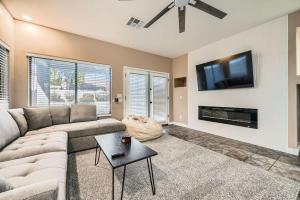 a living room with a couch and a flat screen tv at Whitton House - Hot Tub - Fire Pit - Pets OK in Avondale