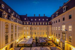 a large building with a courtyard in front of it at Hotel Taschenbergpalais Kempinski in Dresden