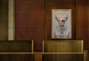 a framed picture of a clown on a wall at Hotel Taschenbergpalais Kempinski in Dresden