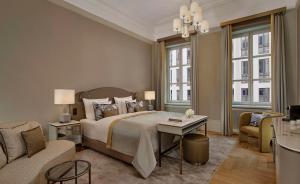 a bedroom with a large bed and a living room at Hotel Taschenbergpalais Kempinski in Dresden