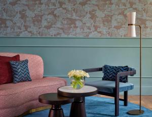 a living room with a couch and a table at Hotel Taschenbergpalais Kempinski in Dresden
