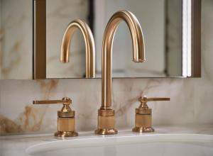 a bathroom sink with two faucets on it at Hotel Taschenbergpalais Kempinski in Dresden