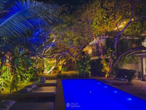 a pool in a backyard at night with lights at Villa Mango Jeri in Jericoacoara
