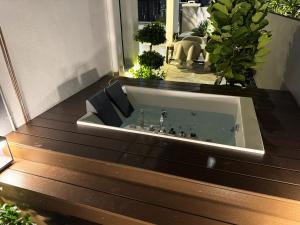a bath tub sitting on top of a house at Ruma Langkawi in Kuah