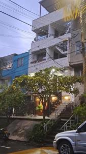 a car parked in front of a building at amplio y comodo apartamento in Medellín